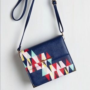 Structured geometric envelope bag.